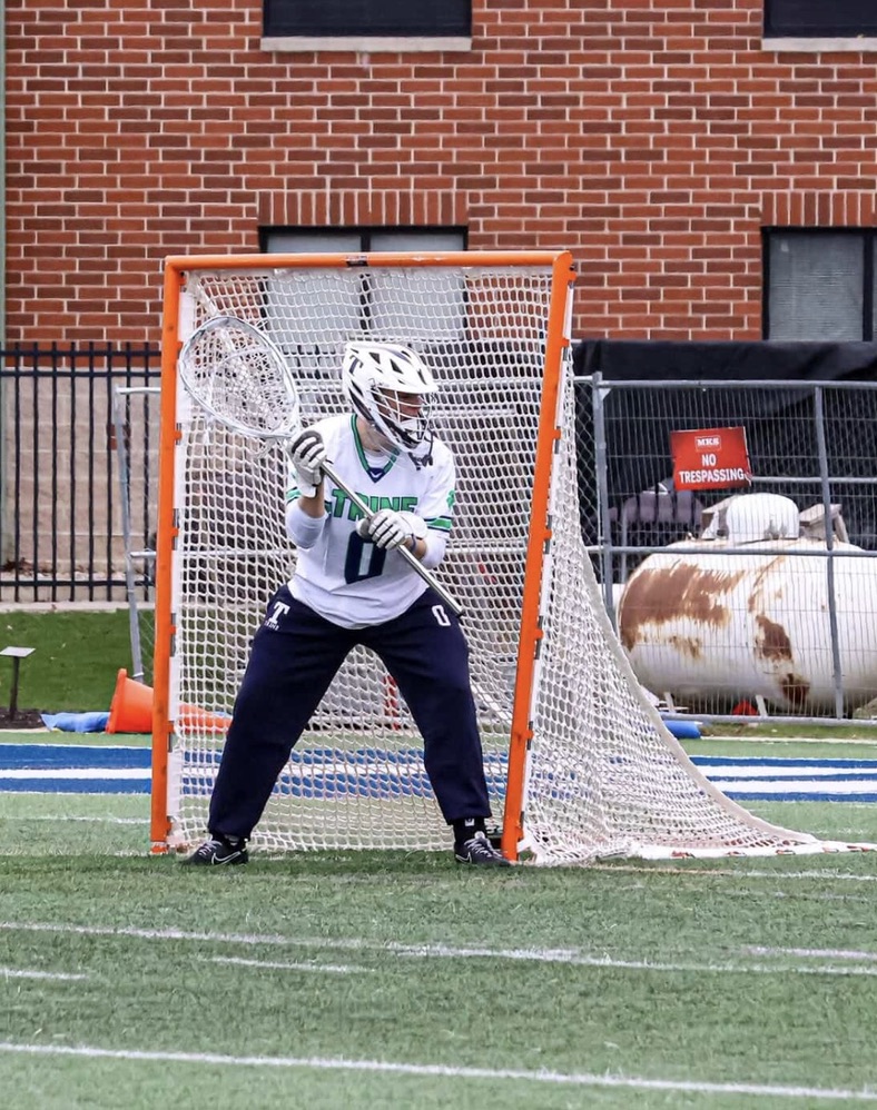 Zade Gawrys playing lacrosse goalie for Trine University